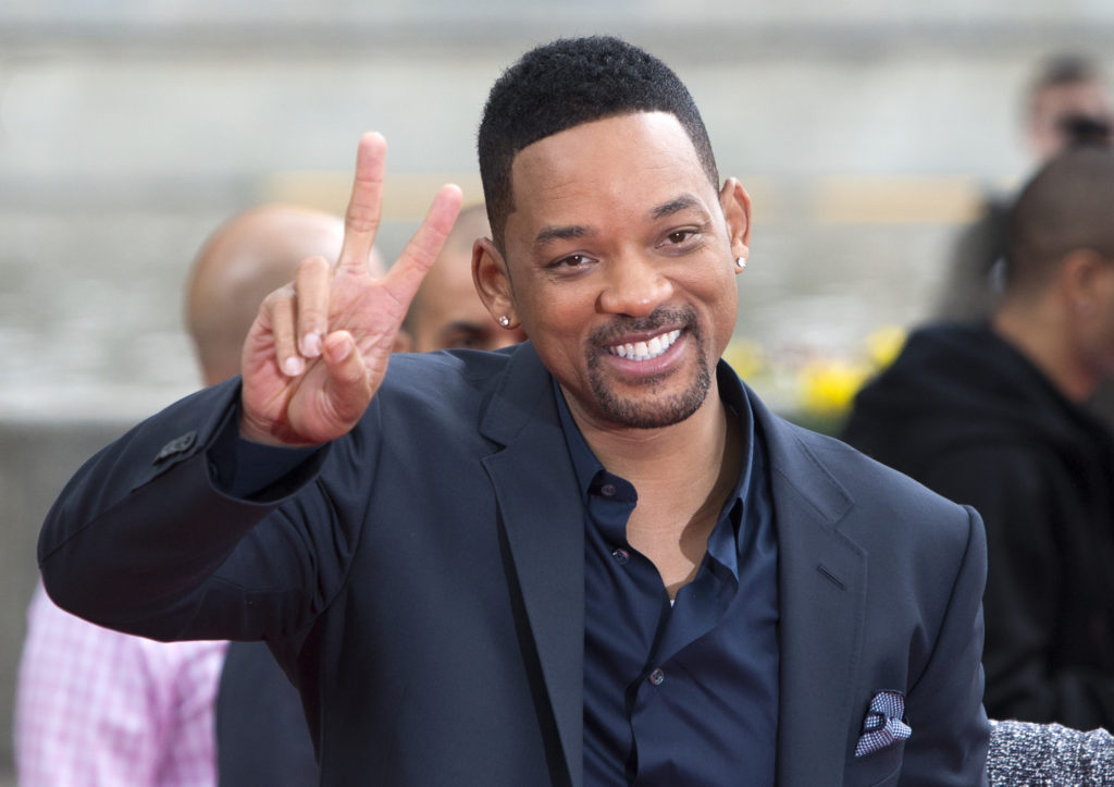 Will Smith putting up a peace sign during a premiere of After Earth in Russia. Photo via Mkaliva
