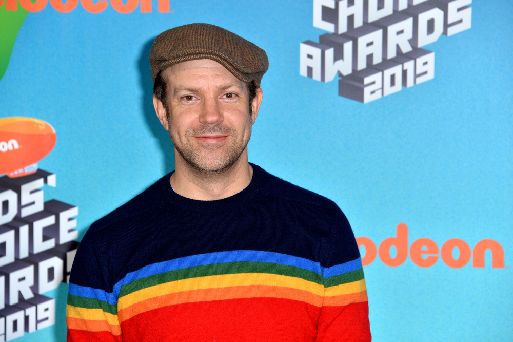 Jason Sudeikis wearing a colorful sweater and hat at the Kids' Choice Awards