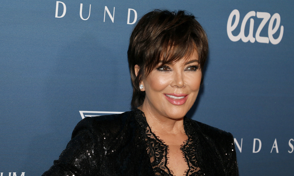 Kris Jenner wearing a black blouse at an event