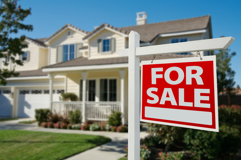 Stock image of a home For Sale with a Real Estate Sign in Front of New House.