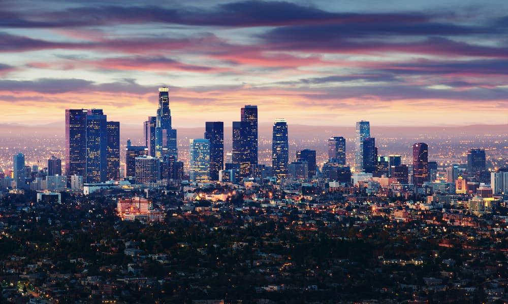 Stock photo of Los Angeles at twilight with lights on and a setting sun