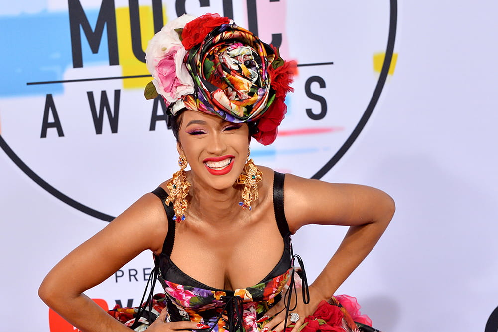 Cardi B wearing colorful floral dress with matching head wrap at 2018 American Music Awards. Photo by Deposit Photos user Featureflash