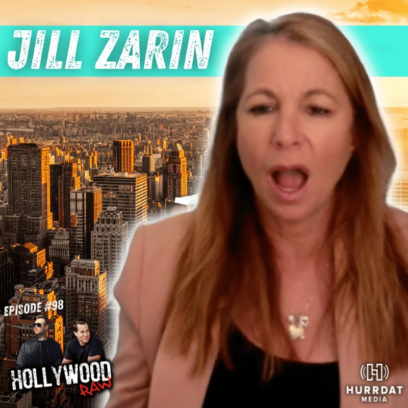 Jill Zarin wearing a pink blazer and black shirt with a gold necklace while talking on the Hollywood Raw Podcast